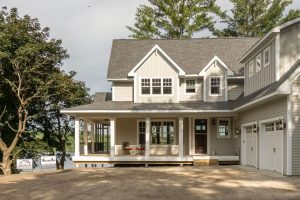 Front view of custom home with wrap around porch and trees, Xpand Inc., home, porch, screen porch, custom porch, custom builder, custom porch builder