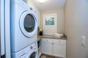 Small laundry room with cabinet space and small window