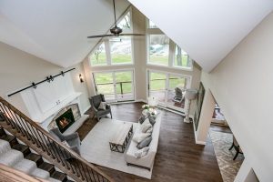 Stairway view overlooking family room with very large windows, wood burning fireplace, fireplace, wood fireplace, wood fire, living room, living room fireplace, fireplace maintenance
