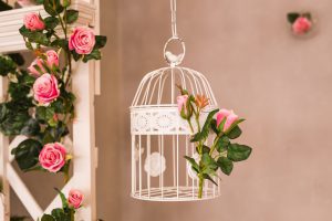 Shabby chic decorating with beautiful vintage birdcage and flowers.