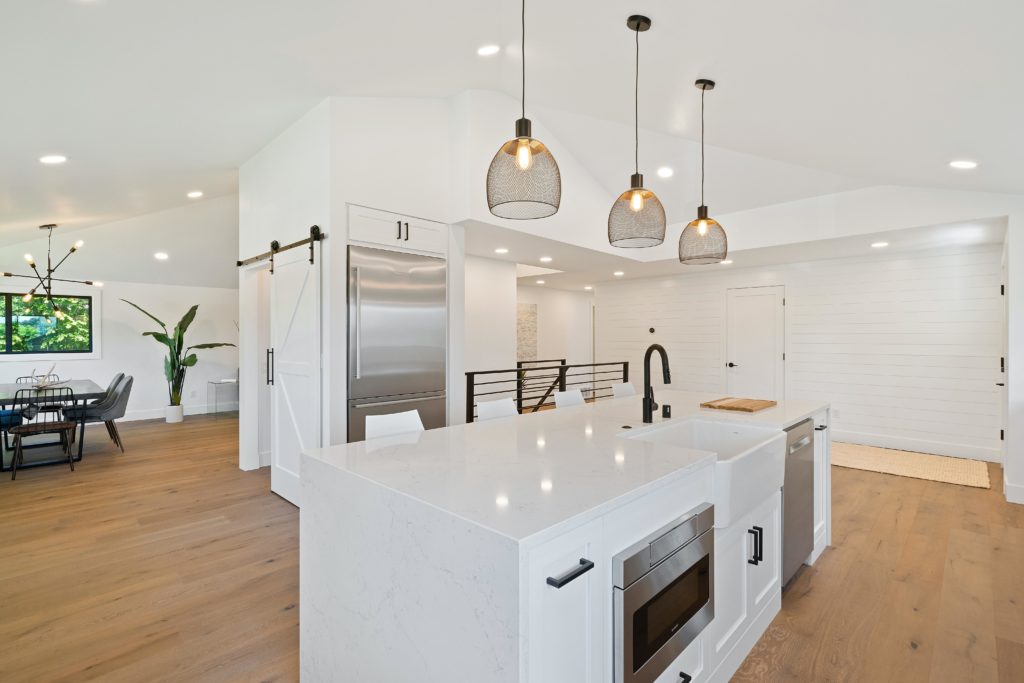 modern white kitchen with an island and overhanging lights, home renovation, home remodel, home, house remodel, house renovation