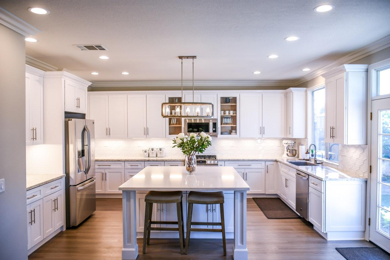 a nice kitchen with white countertops and good lighting throughout